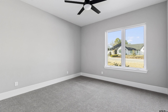 empty room with ceiling fan and carpet