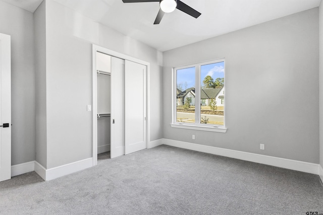 unfurnished bedroom with ceiling fan, carpet floors, and a closet