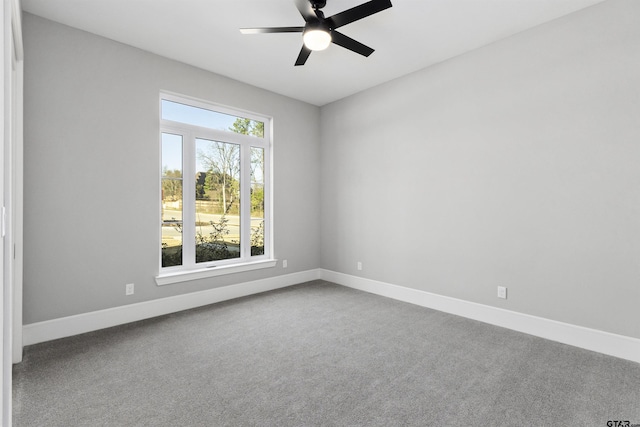 spare room featuring ceiling fan and carpet