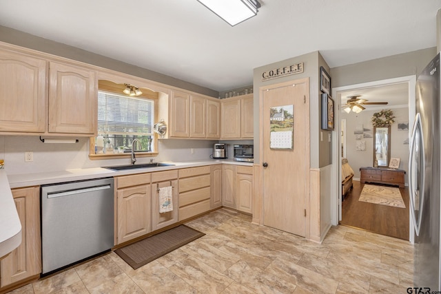 kitchen featuring stainless steel appliances, light brown cabinets, sink, light hardwood / wood-style floors, and ceiling fan