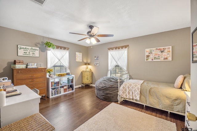 bedroom with dark wood-type flooring and ceiling fan