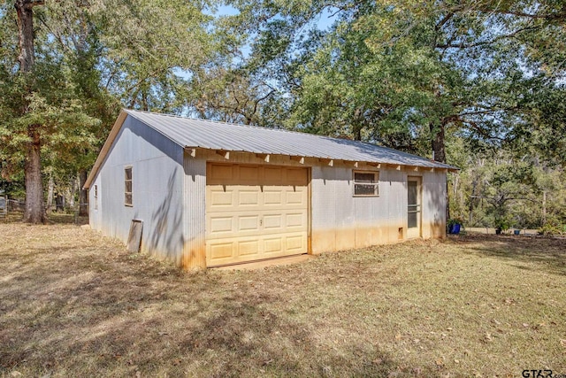 garage featuring a lawn