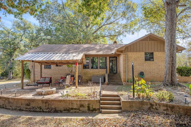 single story home featuring a fire pit and a patio area