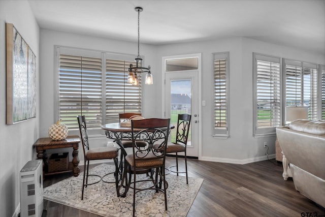 dining space with dark wood finished floors, baseboards, and a wealth of natural light