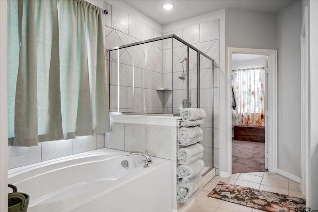 full bathroom with tile patterned floors, a bath, and a shower stall
