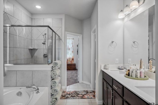 full bath with tile patterned flooring, a sink, a stall shower, a garden tub, and double vanity