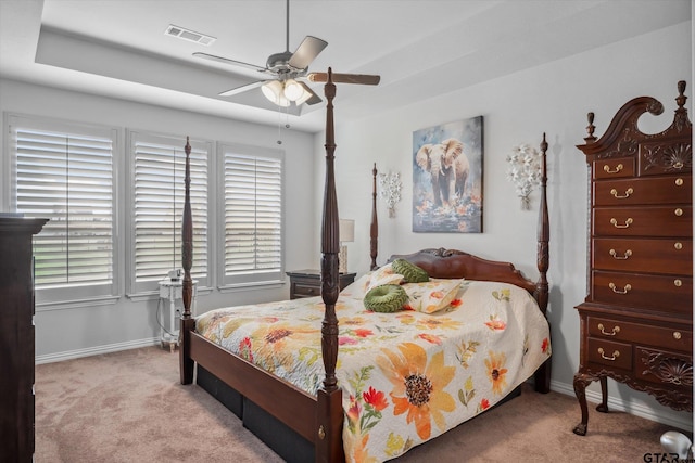 carpeted bedroom with a ceiling fan, baseboards, and visible vents