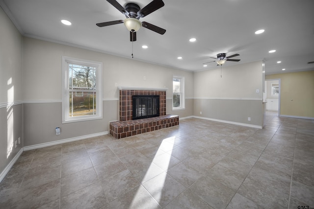 unfurnished living room with ceiling fan, a fireplace, and ornamental molding