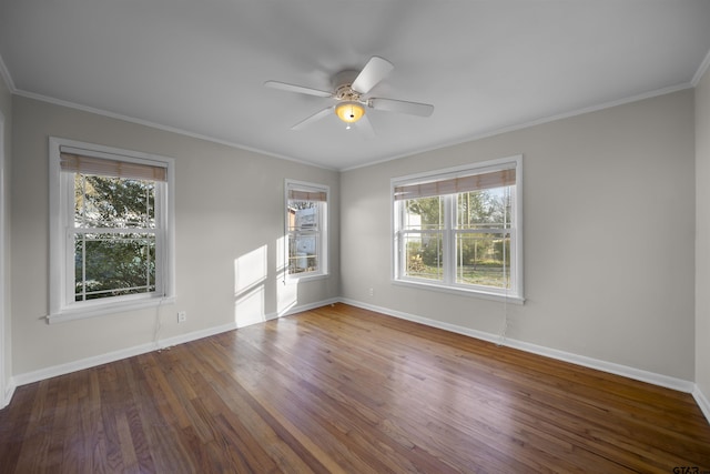 unfurnished room featuring a healthy amount of sunlight, ornamental molding, and hardwood / wood-style floors