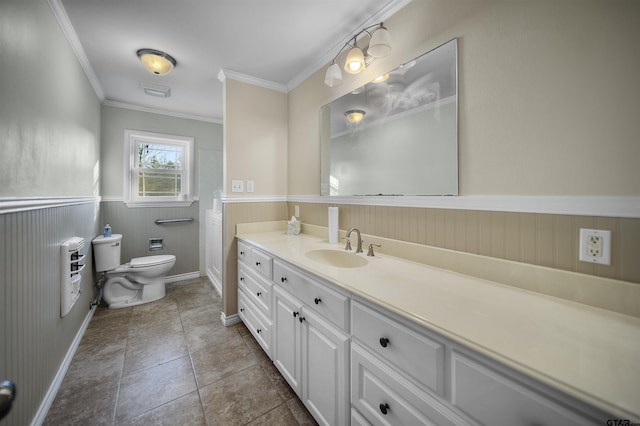 bathroom with toilet, vanity, and ornamental molding