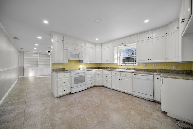 kitchen with sink, white appliances, and white cabinets