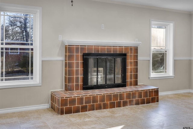 room details with crown molding and a tile fireplace