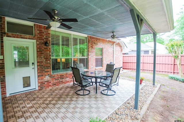 view of patio / terrace featuring fence, ceiling fan, and outdoor dining space