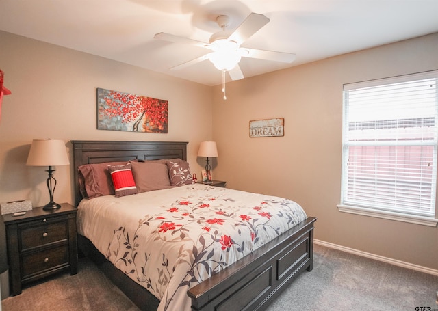 bedroom with dark carpet, a ceiling fan, and baseboards