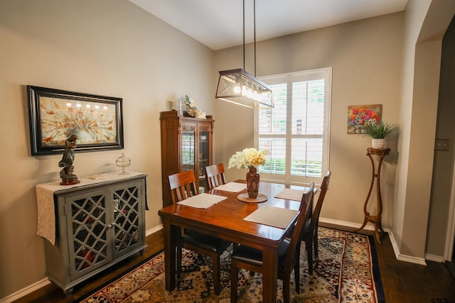 dining area with dark wood finished floors and baseboards