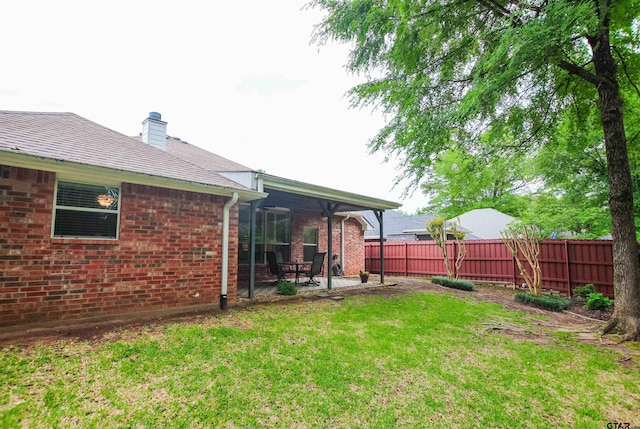 view of yard featuring a patio area and fence