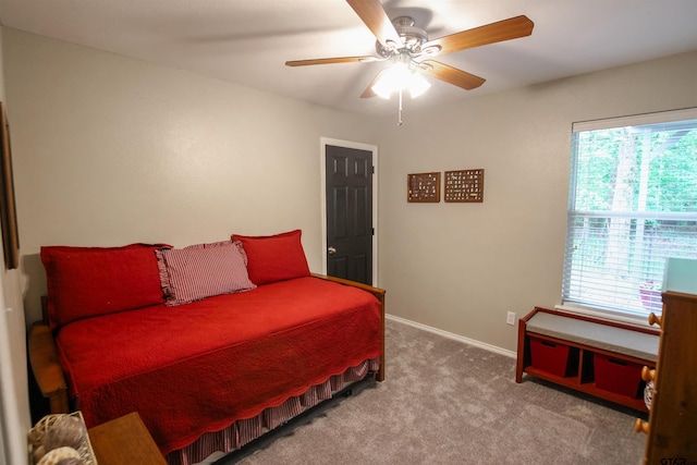 bedroom with carpet flooring, baseboards, and a ceiling fan