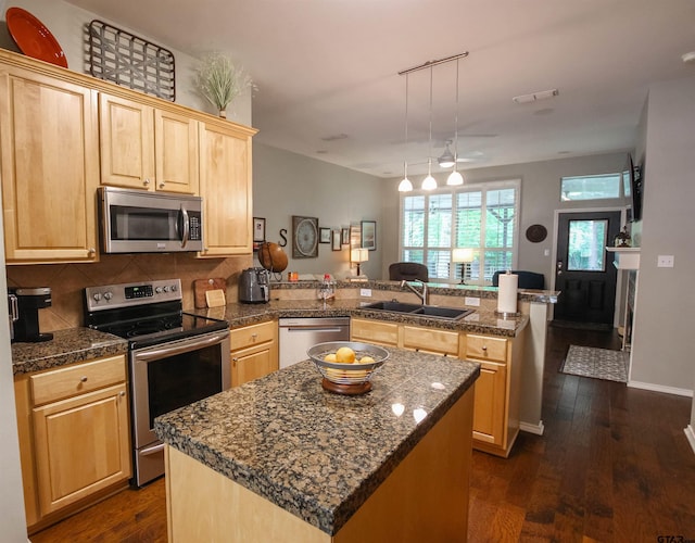 610 Winding Brook Ln, Tyler, TX 75703 - kitchen with tile counters, light brown cabinets, a sink, a peninsula, and appliances with stainless steel finishes