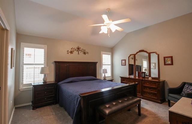 bedroom with multiple windows, vaulted ceiling, baseboards, and light carpet