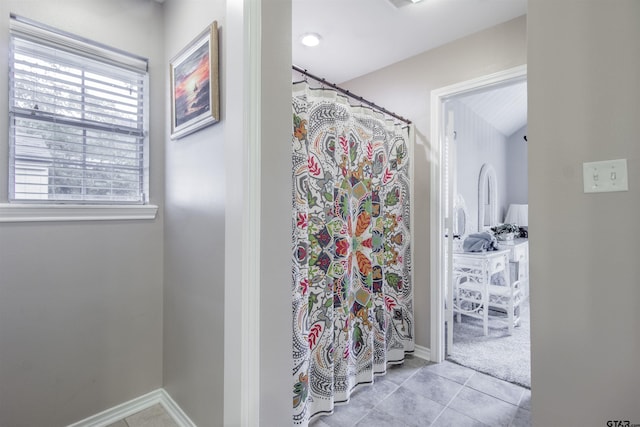 18400 Woodhollow Dr, Flint, TX 75762 - full bath with tile patterned floors, baseboards, and curtained shower
