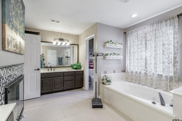 18400 Woodhollow Dr, Flint, TX 75762 - bathroom with vanity, a garden tub, toilet, and tile patterned floors