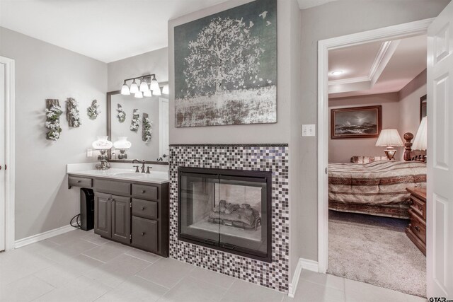 18400 Woodhollow Dr, Flint, TX 75762 - ensuite bathroom with vanity, tile patterned floors, baseboards, a tile fireplace, and crown molding