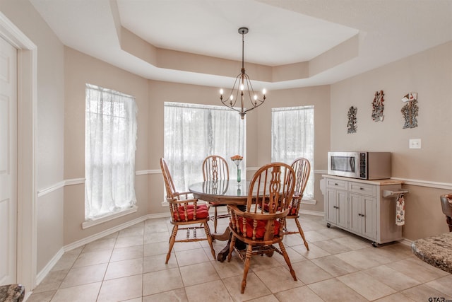 18400 Woodhollow Dr, Flint, TX 75762 - dining space featuring a chandelier, light tile patterned floors, baseboards, and a raised ceiling
