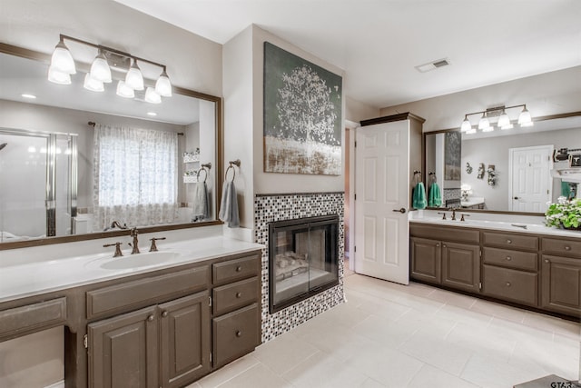 18400 Woodhollow Dr, Flint, TX 75762 - bathroom with two vanities, a stall shower, a tiled fireplace, and tile patterned floors
