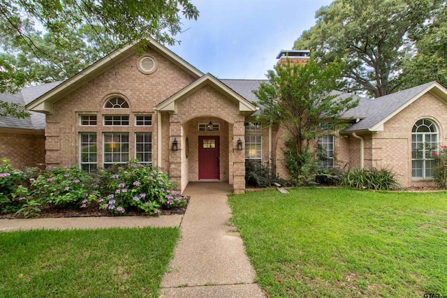 18400 Woodhollow Dr, Flint, TX 75762 - view of front of home with brick siding, a front lawn, and a shingled roof
