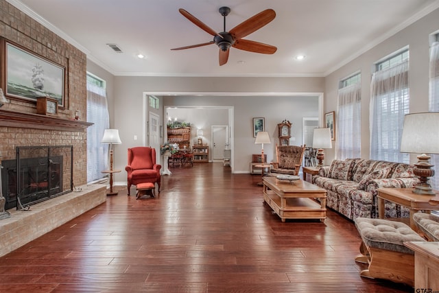 18400 Woodhollow Dr, Flint, TX 75762 - living area featuring dark wood finished floors, ceiling fan, a brick fireplace, crown molding, and recessed lighting