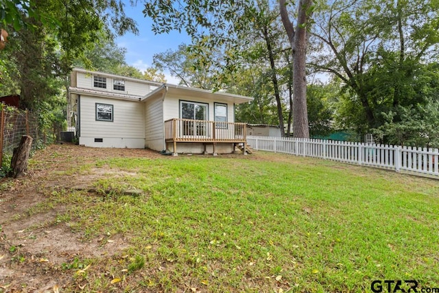 back of property featuring a wooden deck, a yard, and central AC unit