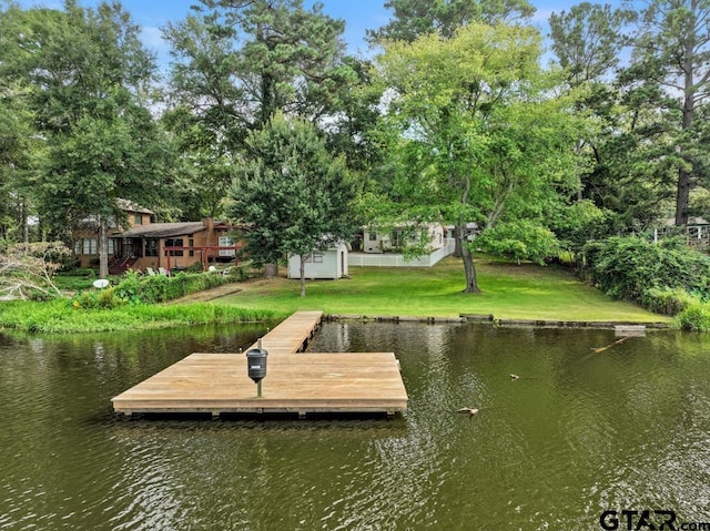 view of dock featuring a yard and a water view