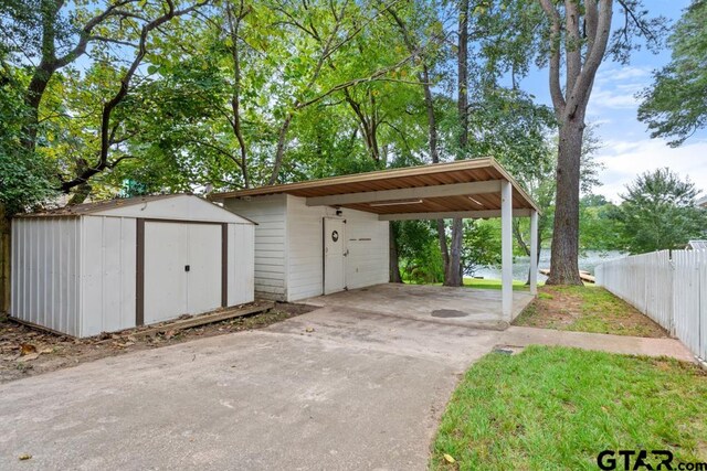 exterior space with a carport and a water view