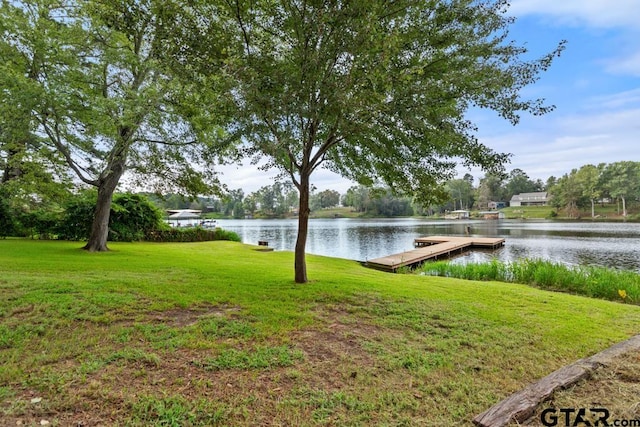 dock area featuring a water view and a yard