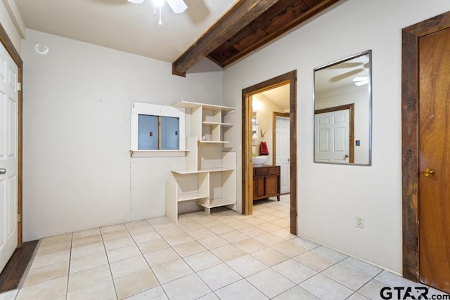 interior space featuring ceiling fan, electric panel, and beam ceiling