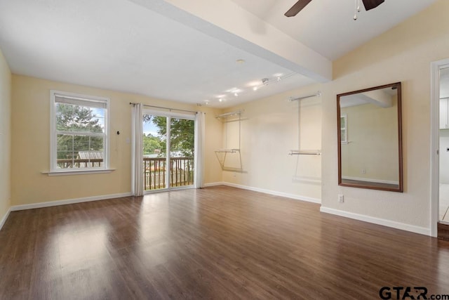 unfurnished room with ceiling fan, dark wood-type flooring, and beamed ceiling