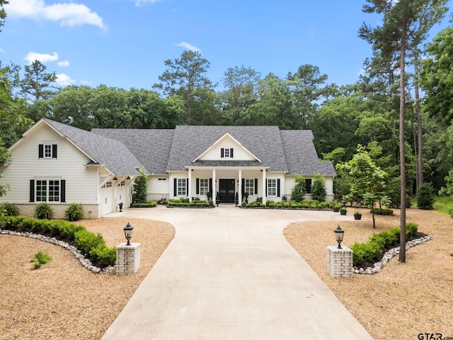 14698 Jade Forest Trl, Tyler, TX 75707 - modern inspired farmhouse with curved driveway, a garage, and a shingled roof