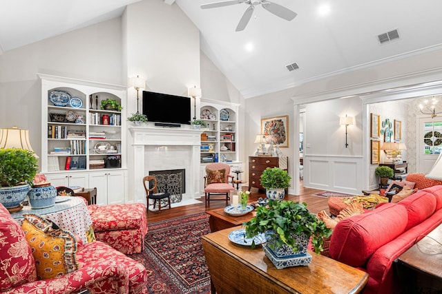 14698 Jade Forest Trl, Tyler, TX 75707 - living room featuring wood finished floors, a ceiling fan, high vaulted ceiling, a fireplace, and built in shelves