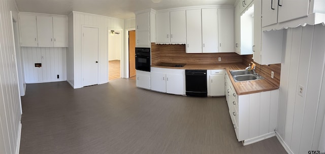 kitchen with dark wood-style flooring, a sink, black appliances, light countertops, and white cabinetry