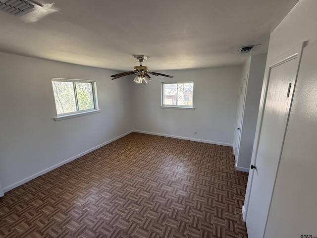 unfurnished bedroom with visible vents, a ceiling fan, and baseboards