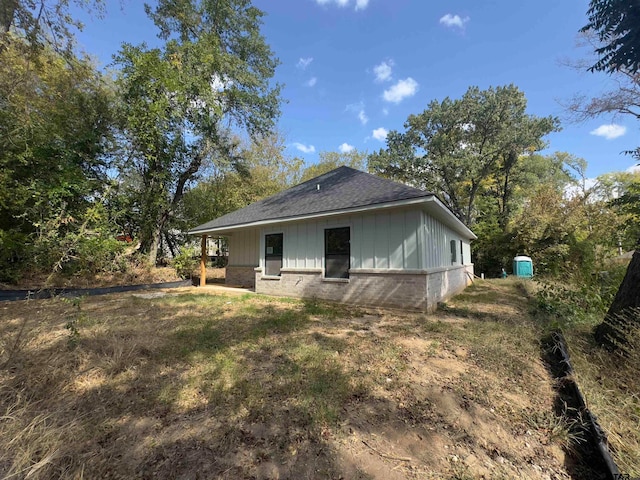 view of side of property featuring a shed