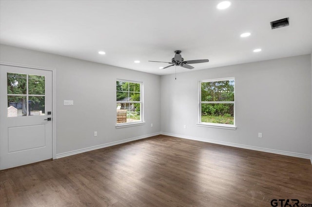 interior space with a ceiling fan, baseboards, recessed lighting, dark wood-type flooring, and visible vents