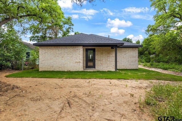 back of property with roof with shingles