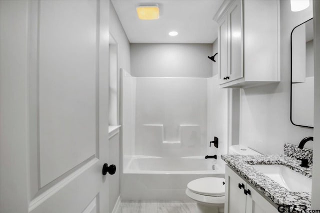bathroom featuring bathing tub / shower combination, vanity, and toilet