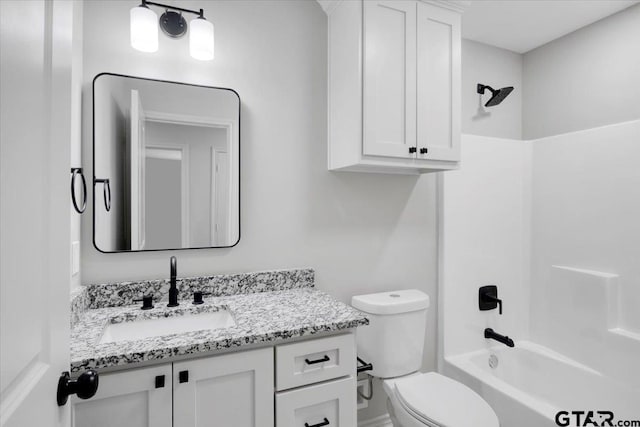 bathroom with vanity, bathing tub / shower combination, and toilet