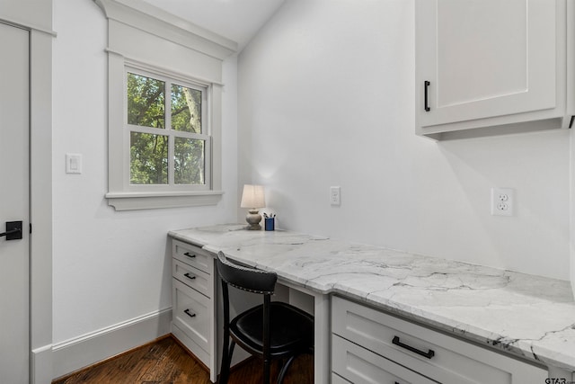 office featuring dark hardwood / wood-style floors and built in desk