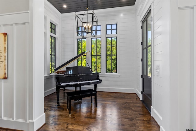 miscellaneous room with dark hardwood / wood-style flooring and a notable chandelier