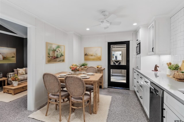 dining area with ceiling fan and crown molding