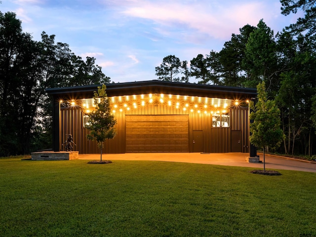 garage at dusk with a yard