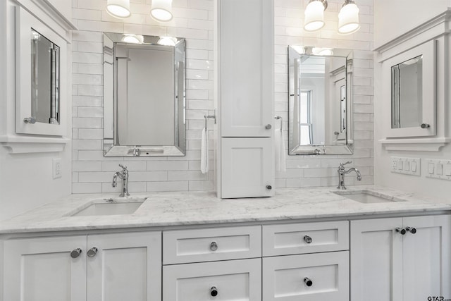 bathroom featuring vanity and tasteful backsplash